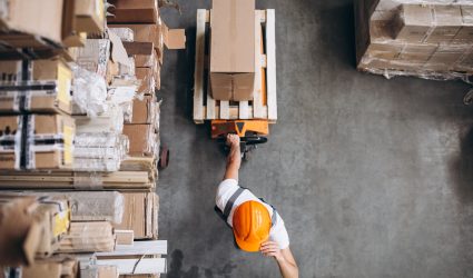 Young man working at a warehouse with boxes